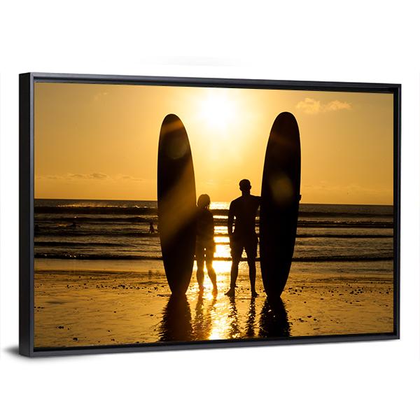 Surfer Couple Holding Long Surf Boards At Sunset On Beach Canvas Wall Art-5 Horizontal-Gallery Wrap-22" x 12"-Tiaracle