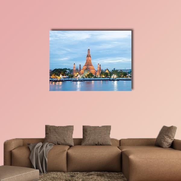 Wat Arun Twilight Cityscape Canvas Wall Art in gold, orange and blue, single panel hung on a wall