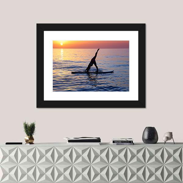 Paddleboard Yoga at Sunset Canvas Wall Art in orange, yellow and blue, single panel hung on a wall
