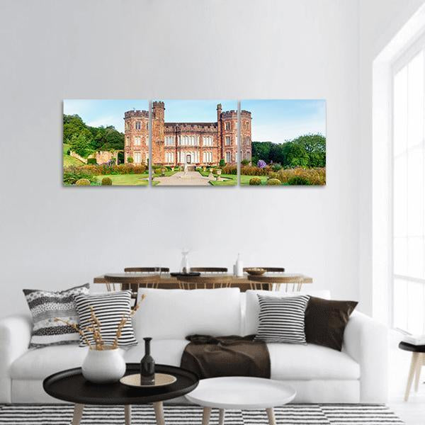 Mount Edgcumbe Manor House Panoramic Canvas Wall Art in brown, green and blue, hung on a wall