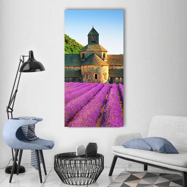 Sénanque Abbey with Lavender Field Vertical Canvas Wall Art in green, blue and purple, single vertical panel hung on a wall