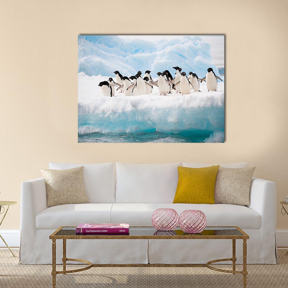 Penguins on Iceberg Canvas Wall Art in white and blue, single panel hung on a wall