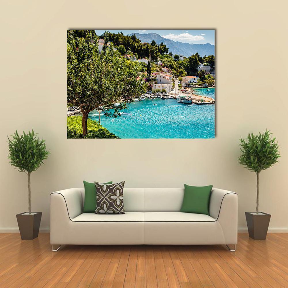 Adriatic Bay Village Canvas Wall Art in green and blue, single panel hung on a wall