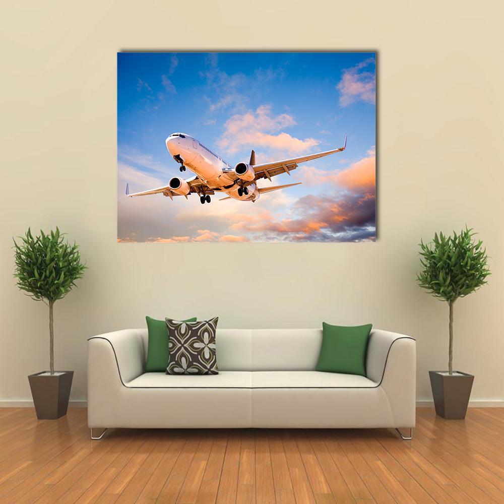 Passenger Jet at Sunset Canvas Wall Art in white, orange and blue, single panel hung on a wall