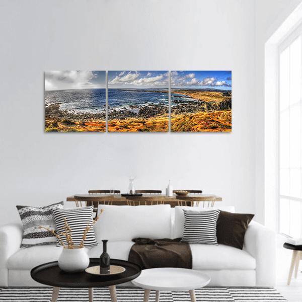 Coastal Shoreline with Ocean Waves Panoramic Canvas Wall Art in brown, yellow and blue, hung on a wall