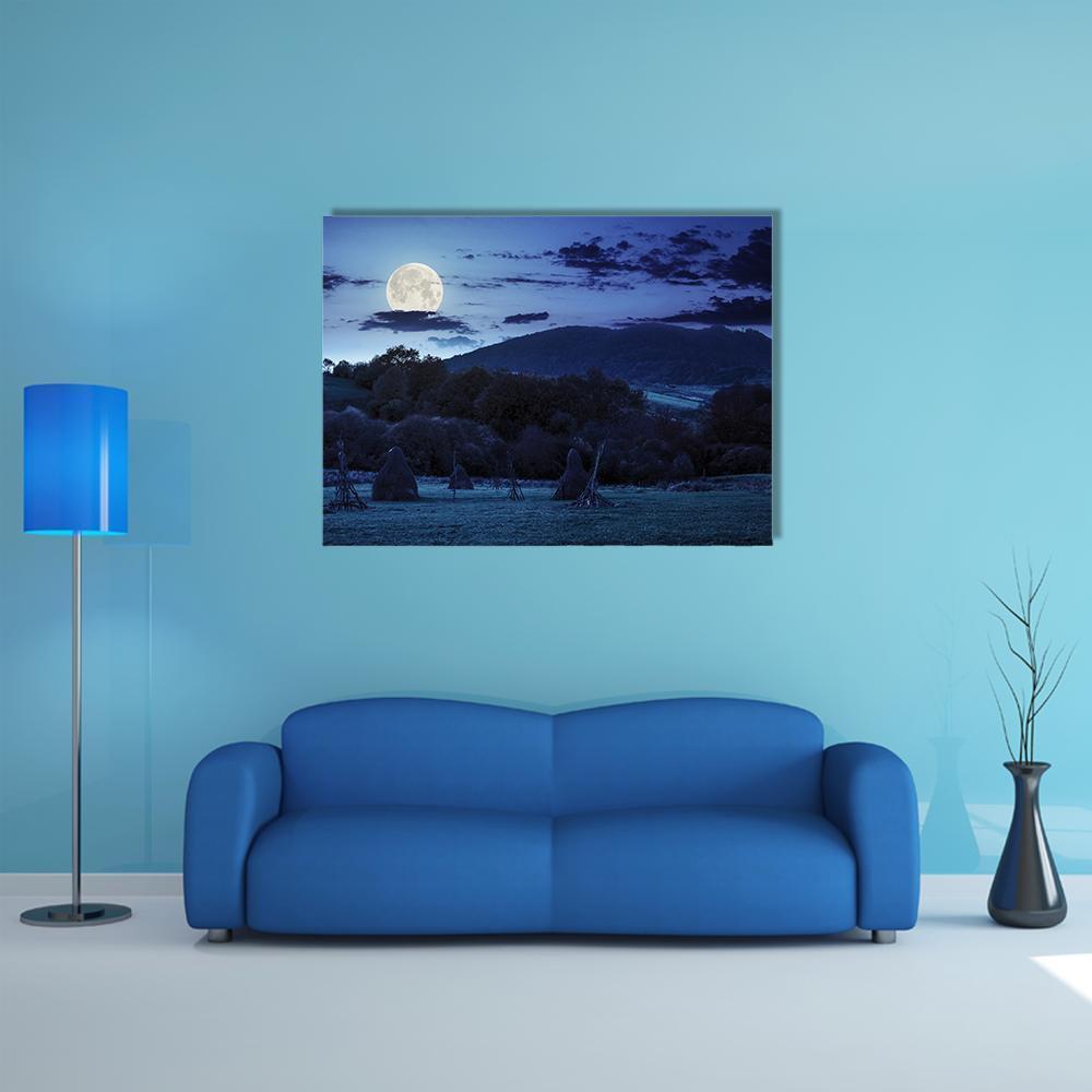 Moonlit Haystacks and Mountains Canvas Wall Art in black, blue and navy, single panel hung on a wall