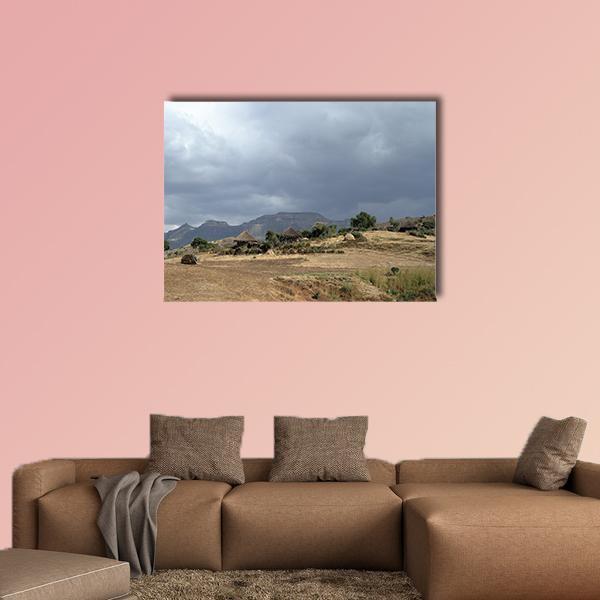 Thatched Huts in Rural Africa Canvas Wall Art in gray, beige and brown, single panel hung on a wall