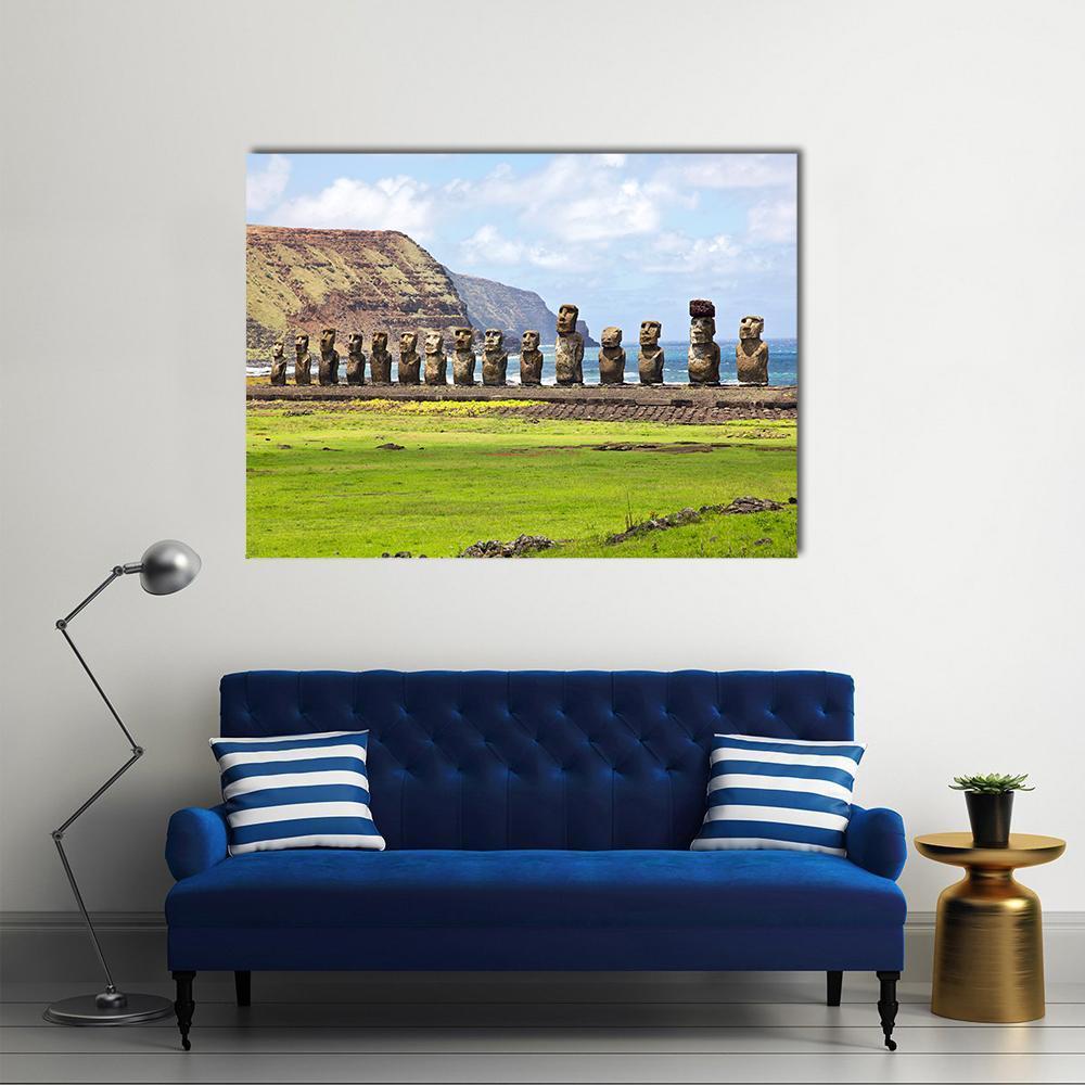 Ahu Tongariki Moai Along the Coast Canvas Wall Art in brown, green and blue, single panel hung on a wall