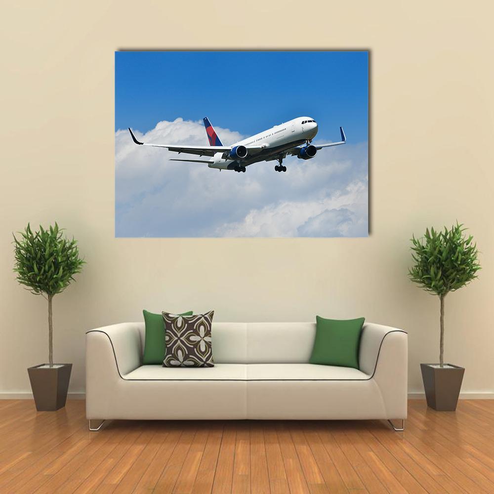Delta Airplane Approaching Canvas Wall Art in white and blue, single panel hung on a wall