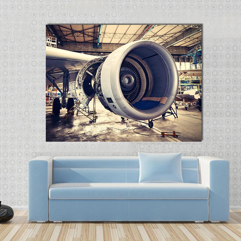 Airplane Engine Maintenance Canvas Wall Art in gray, beige and silver, single panel hung on a wall