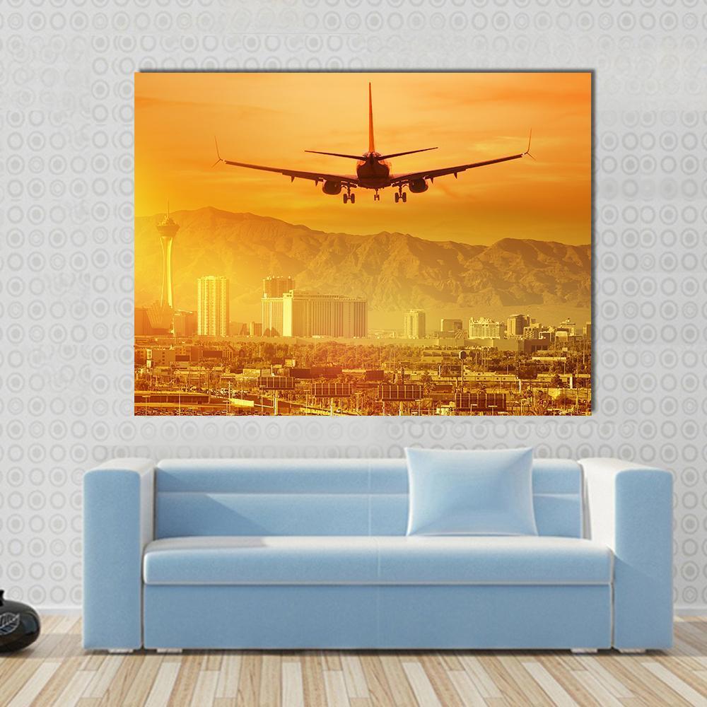 Airplane Flying Above City Canvas Wall Art in gold, orange and yellow, single panel hung on a wall