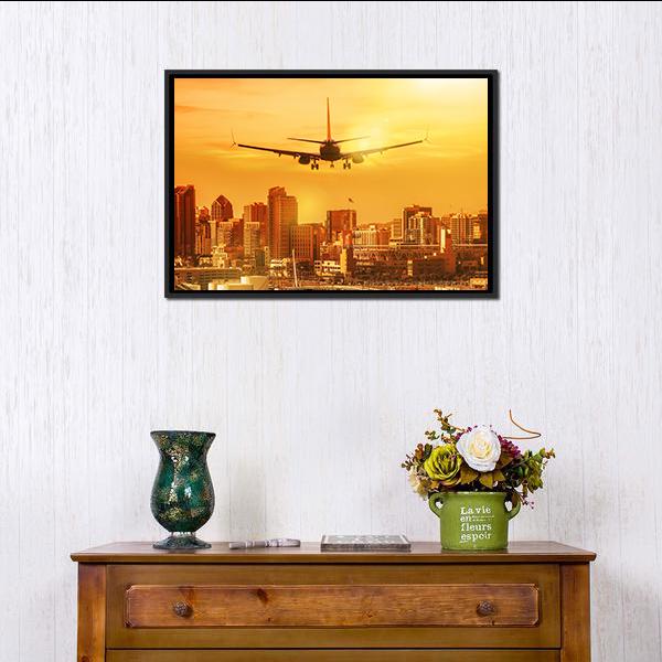 Airplane Flying Towards City Skyline Canvas Wall Art in brown, orange and yellow, framed canvas, product view on a white background
