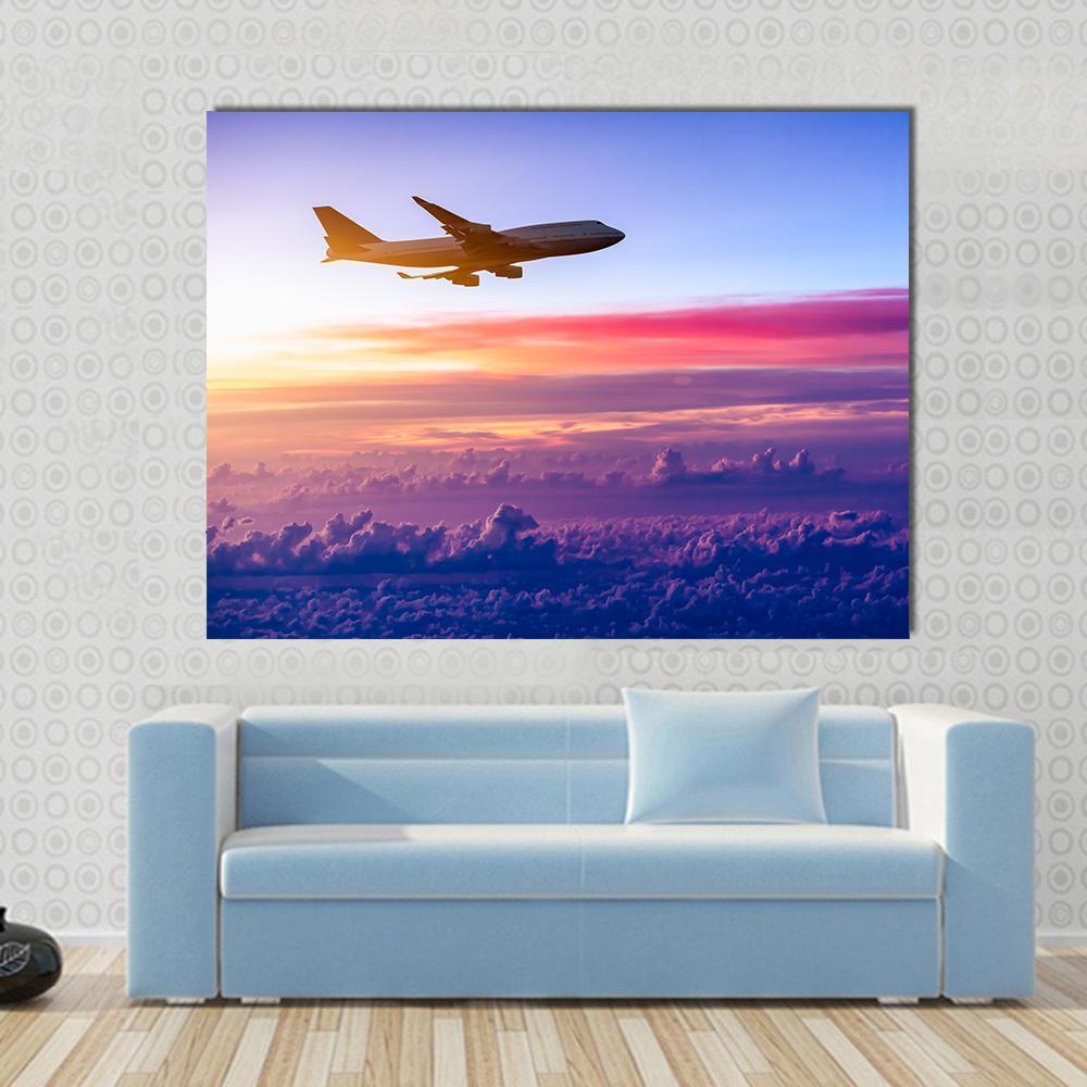 Airplane in the Sky Canvas Wall Art in blue, purple and pink, single panel hung on a wall