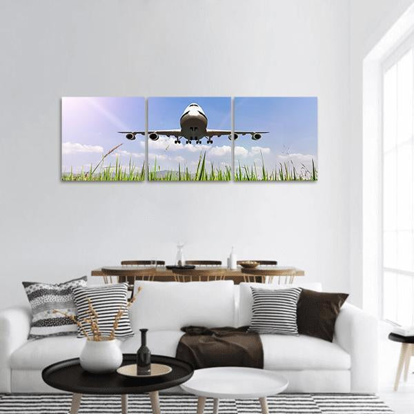 Jumbo Jet Taking Off Panoramic Canvas Wall Art in white, green and blue, hung on a wall