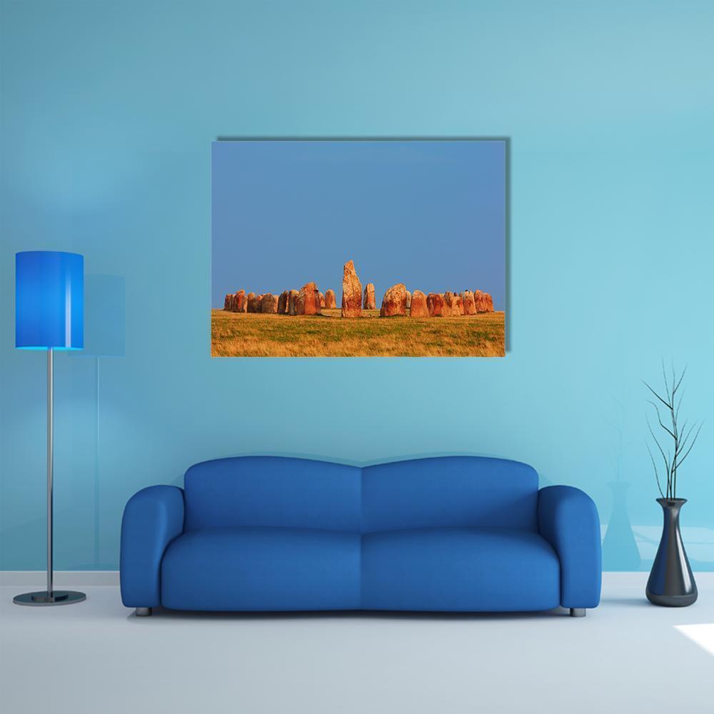 Ale Stones, Sweden at Golden Hour Canvas Wall Art in brown, orange and blue, single panel hung on a wall