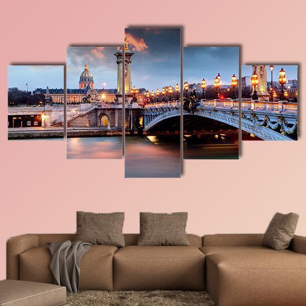 Alexandre Iii Bridge in Paris Canvas Wall Art in gold, orange and blue, 5 panel Star layout hung on a wall
