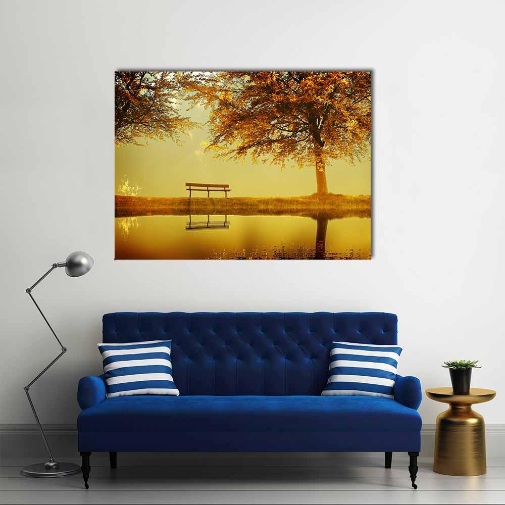 Solitary Bench in Autumn Park Canvas Wall Art in brown, orange and yellow, single panel hung on a wall