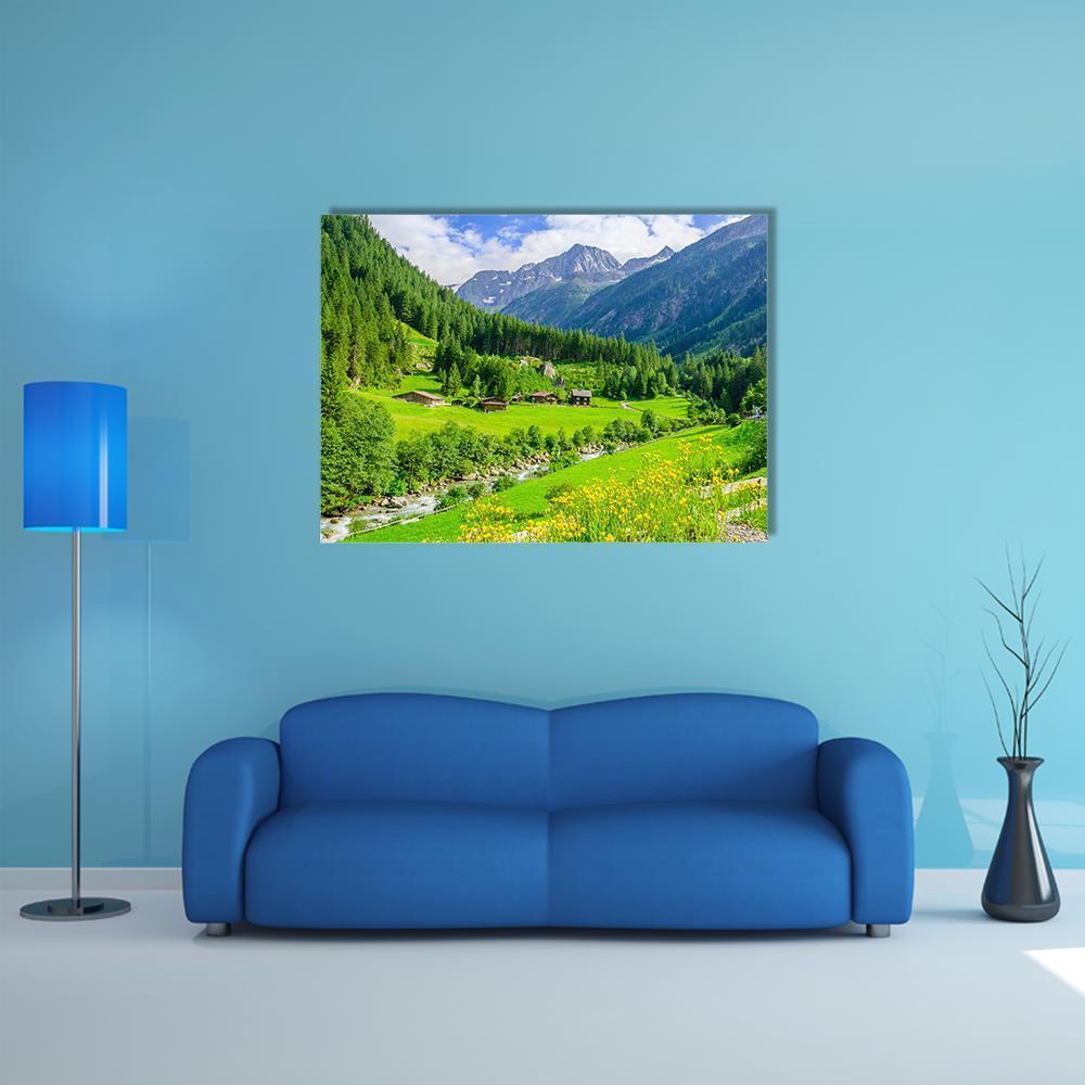 Alpine Cottages in Mountain Valley Canvas Wall Art in green and blue, single panel hung on a wall