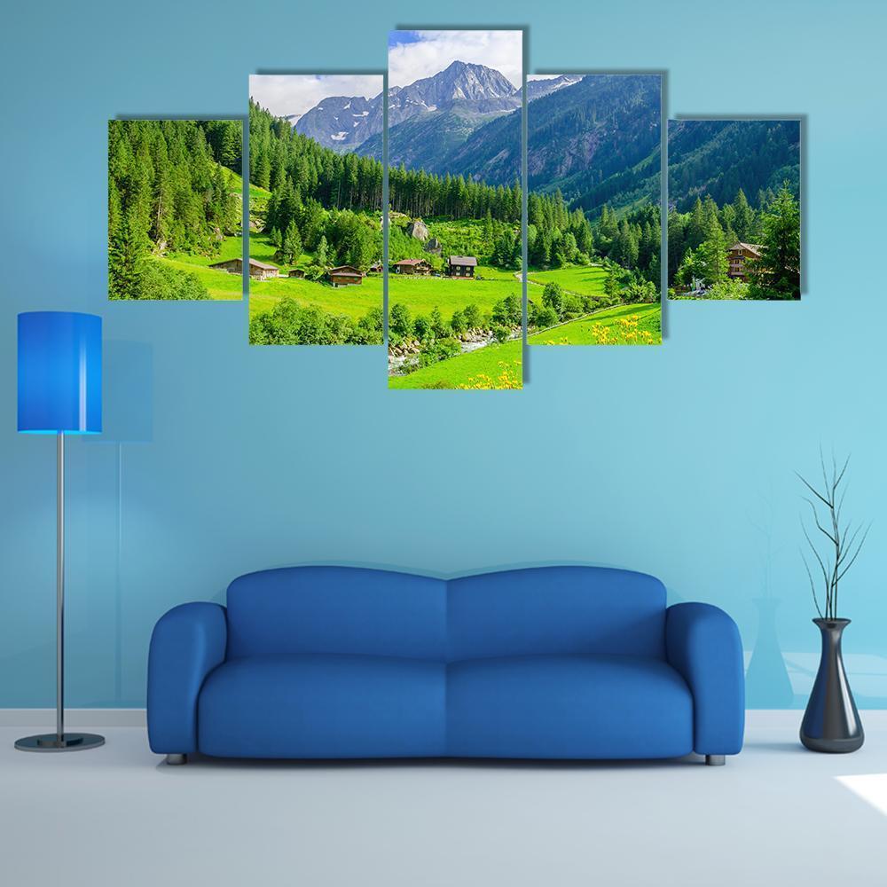 Alpine Cottages in Mountain Valley Canvas Wall Art in green and blue, 5 panel Star layout hung on a wall