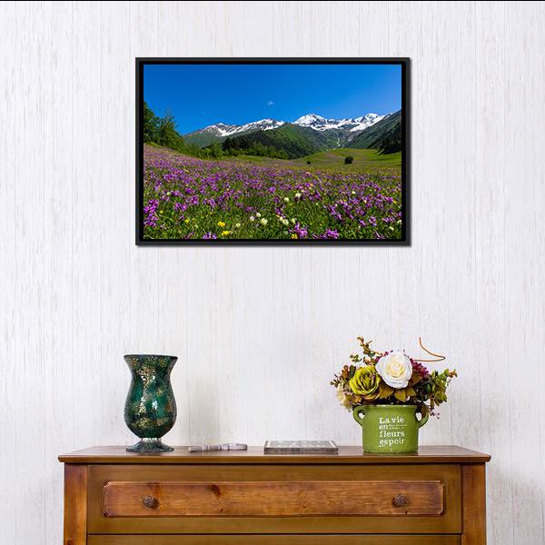 Alpine Fields with Purple Flowers Canvas Wall Art in green, blue and purple, framed canvas, product view on a white background
