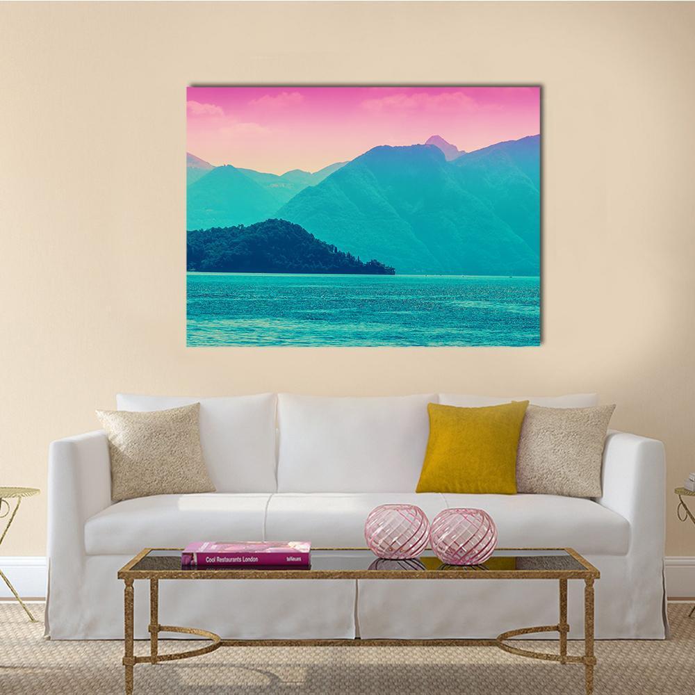 Alpine Mountains Over Lake Como Canvas Wall Art in blue and pink, single panel hung on a wall