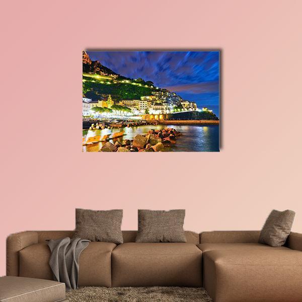 Hillside Harbor Village at Night Canvas Wall Art in yellow, green and blue, single panel hung on a wall