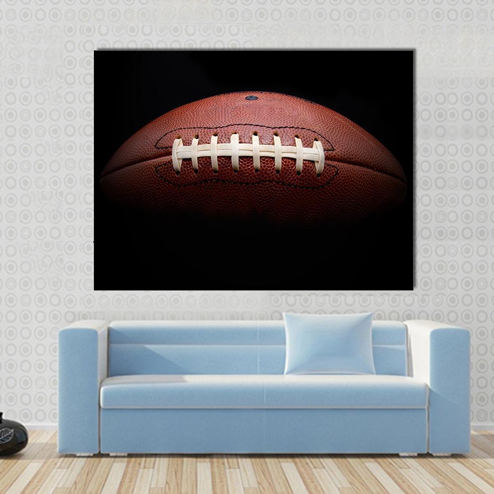 American Football Canvas Wall Art in black and brown, single panel hung on a wall