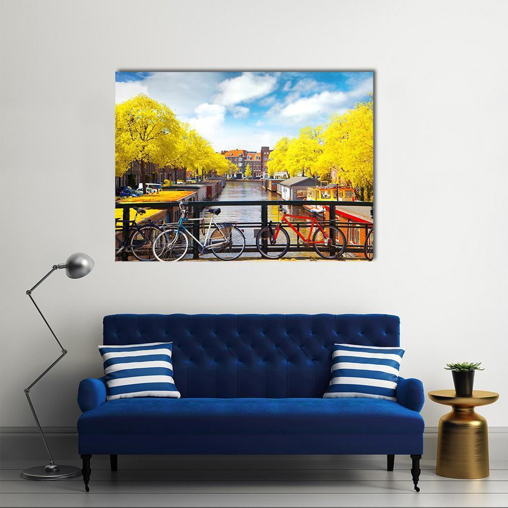 Amsterdam Canal in Autumn Canvas Wall Art in brown, yellow and blue, single panel hung on a wall