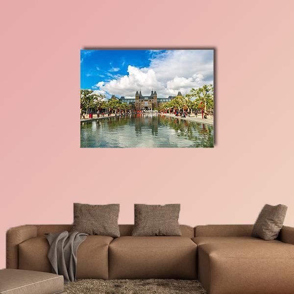 Amsterdam Museum with Pond Reflection Canvas Wall Art in white, green and blue, single panel hung on a wall