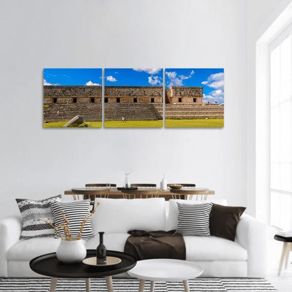 Ancient Maya City Ruins Panoramic Canvas Wall Art in brown, green and blue, hung on a wall
