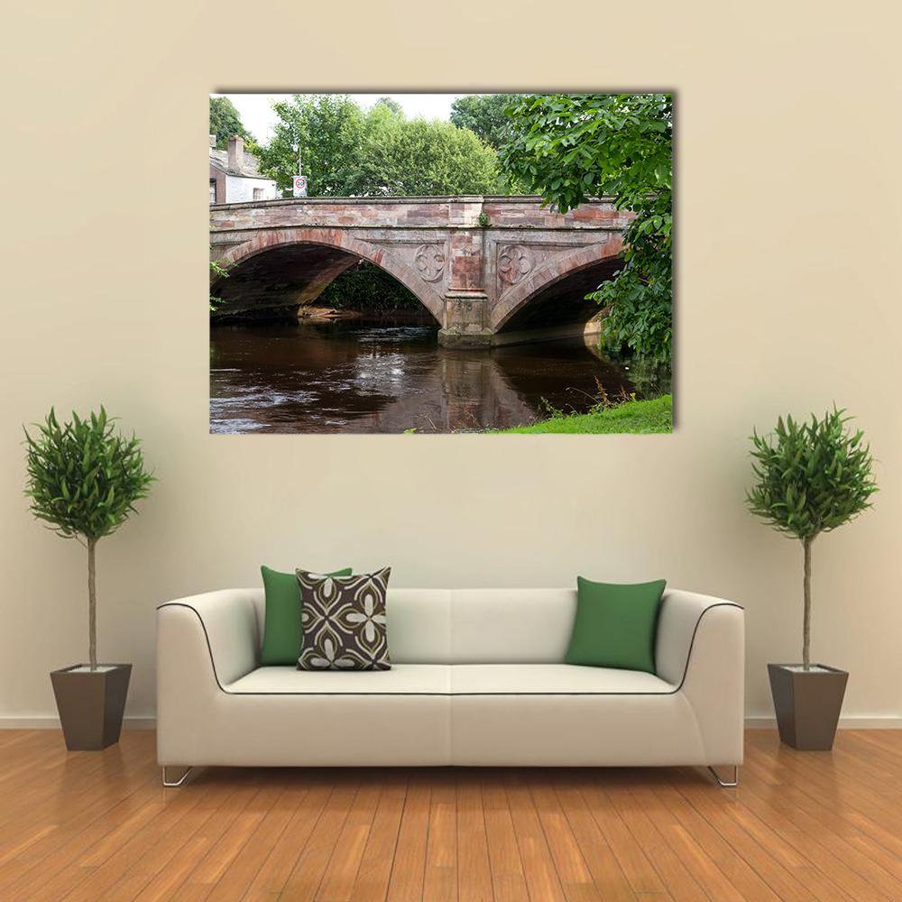 Ancient Stone Bridge Canvas Wall Art in gray, brown and green, single panel hung on a wall