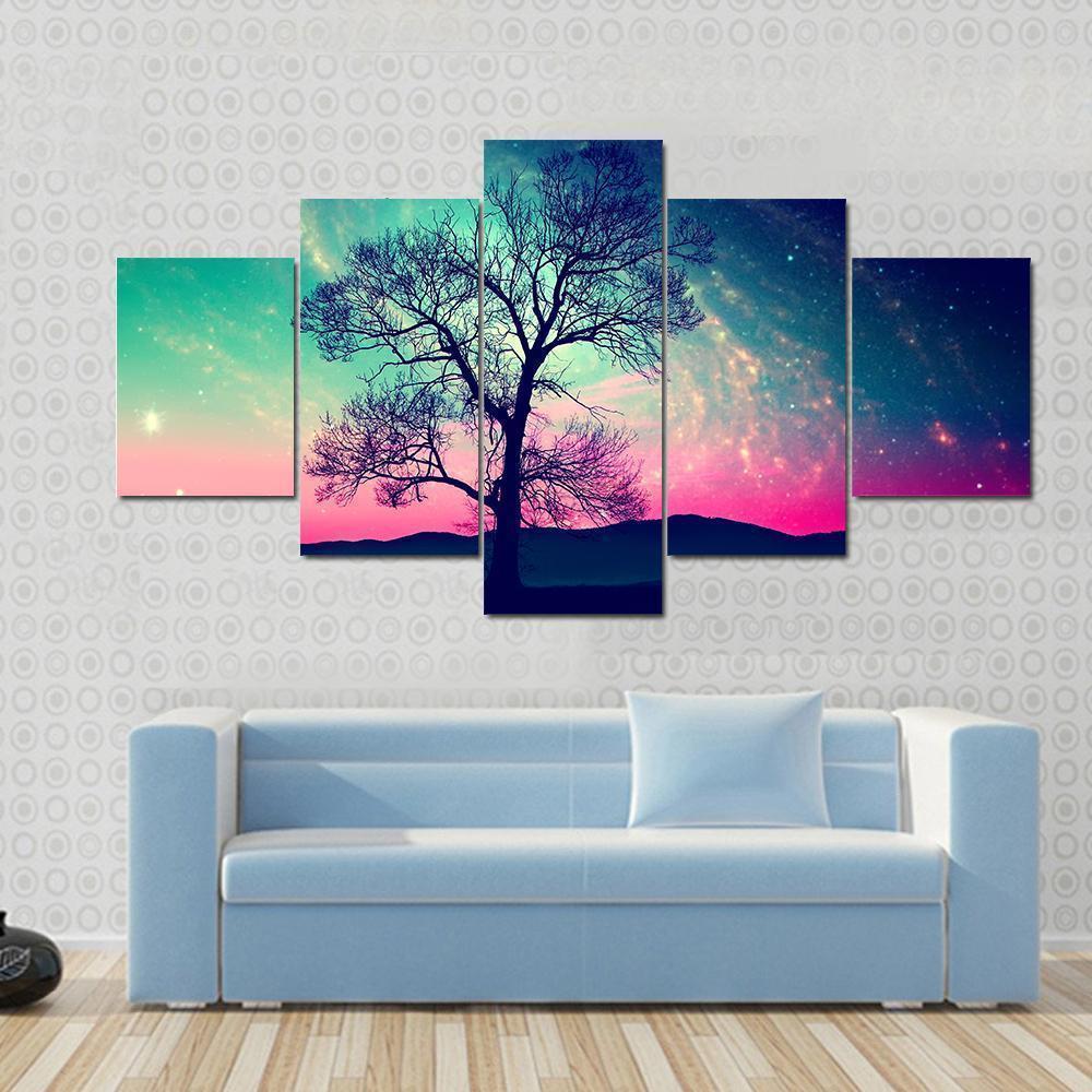 Andromeda Galaxy Over Earth Canvas Wall Art in blue, purple and pink, 5 panel Star layout hung on a wall