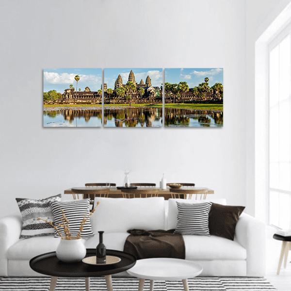Angkor Wat Temple with Reflecting Pond Panoramic Canvas Wall Art in brown, green and blue, hung on a wall