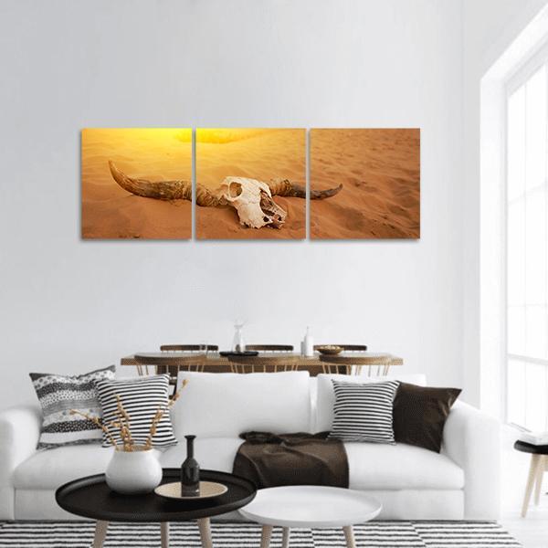 Bleached Skull on Desert Dunes Panoramic Canvas Wall Art in beige, brown and yellow, hung on a wall