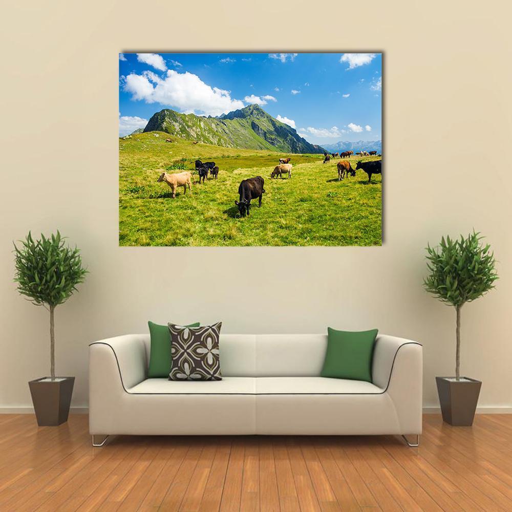 Herd of Cows in Alpine Meadow Canvas Wall Art in green and blue, single panel hung on a wall