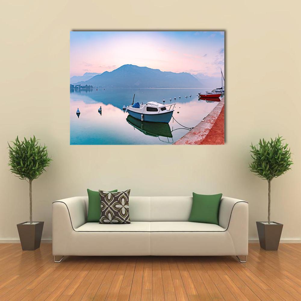 Annecy Lake Sunrise with White Boat Canvas Wall Art in white, blue and pink, single panel hung on a wall