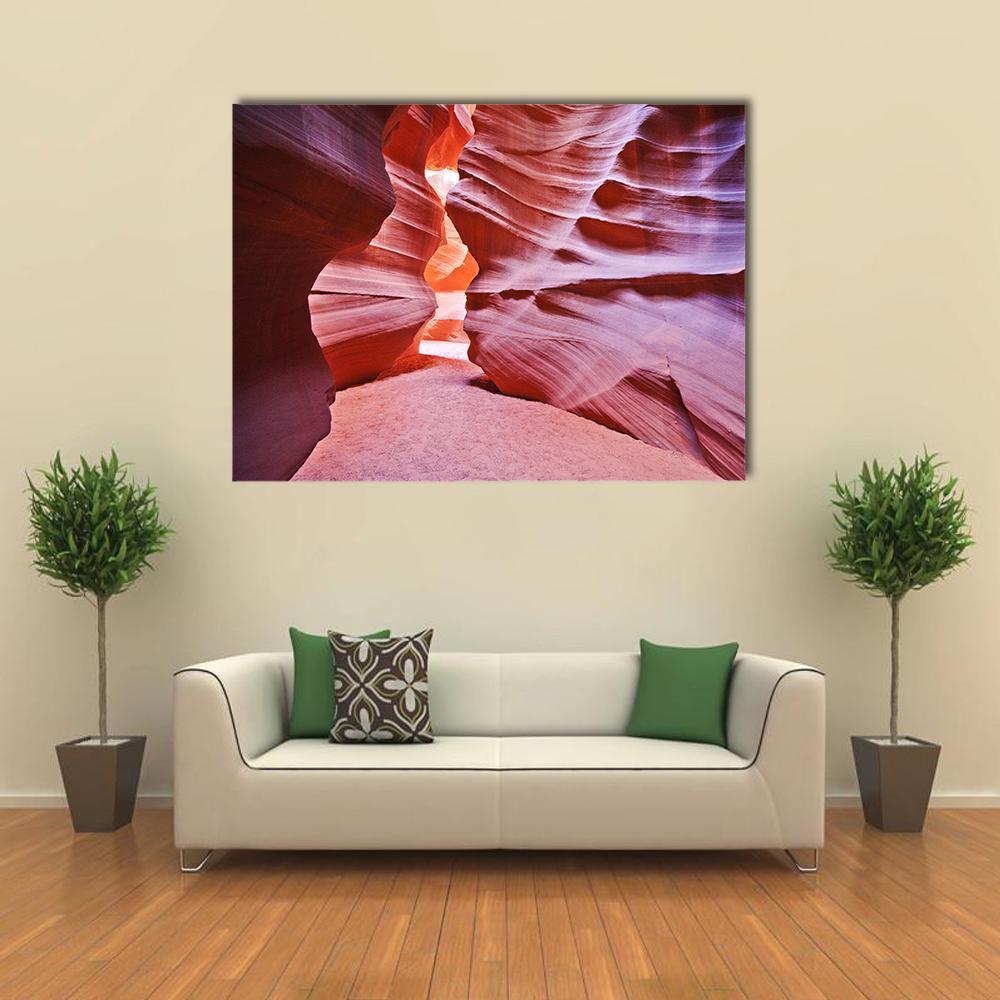 Antelope Canyon Canvas Wall Art in orange, purple and pink, single panel hung on a wall
