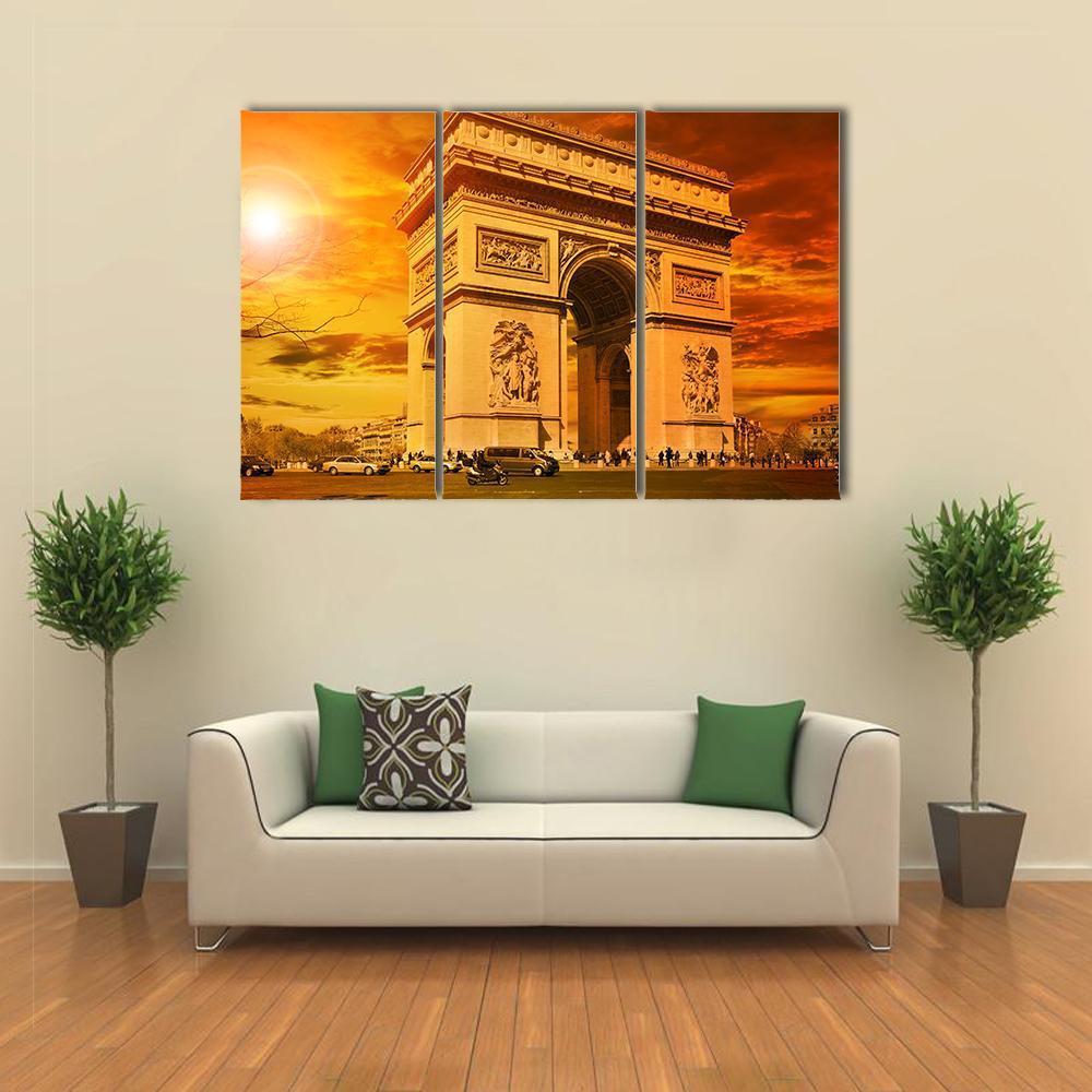 Arc De Triomphe at Sunset Canvas Wall Art in brown, orange and yellow, 3 panel horizontal set hung on a wall