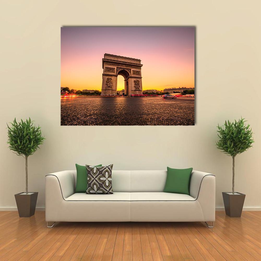 Arc De Triomphe at Golden Hour Canvas Wall Art in orange, yellow and purple, hung on a wall