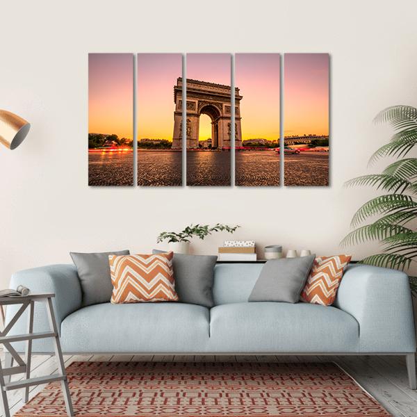 Arc De Triomphe at Golden Hour Canvas Wall Art in orange, yellow and purple, hung on a wall