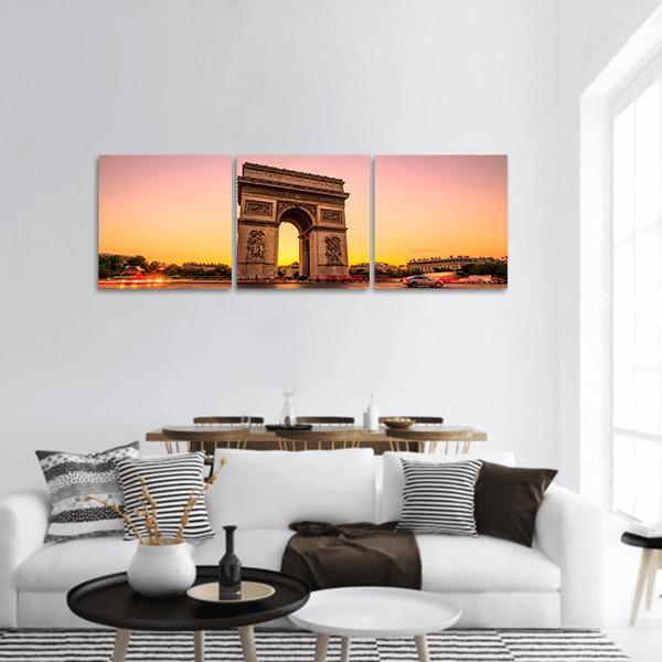 Arc De Triomphe at Sunset Panoramic Canvas Wall Art in orange, yellow and pink, hung on a wall