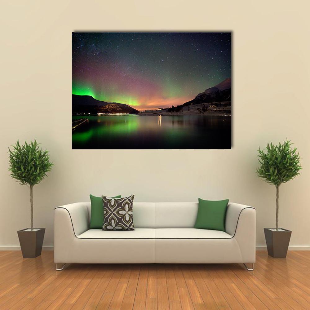 Aurora Over Snow-capped Mountains and Lake Canvas Wall Art in black, green and purple, single panel hung on a wall