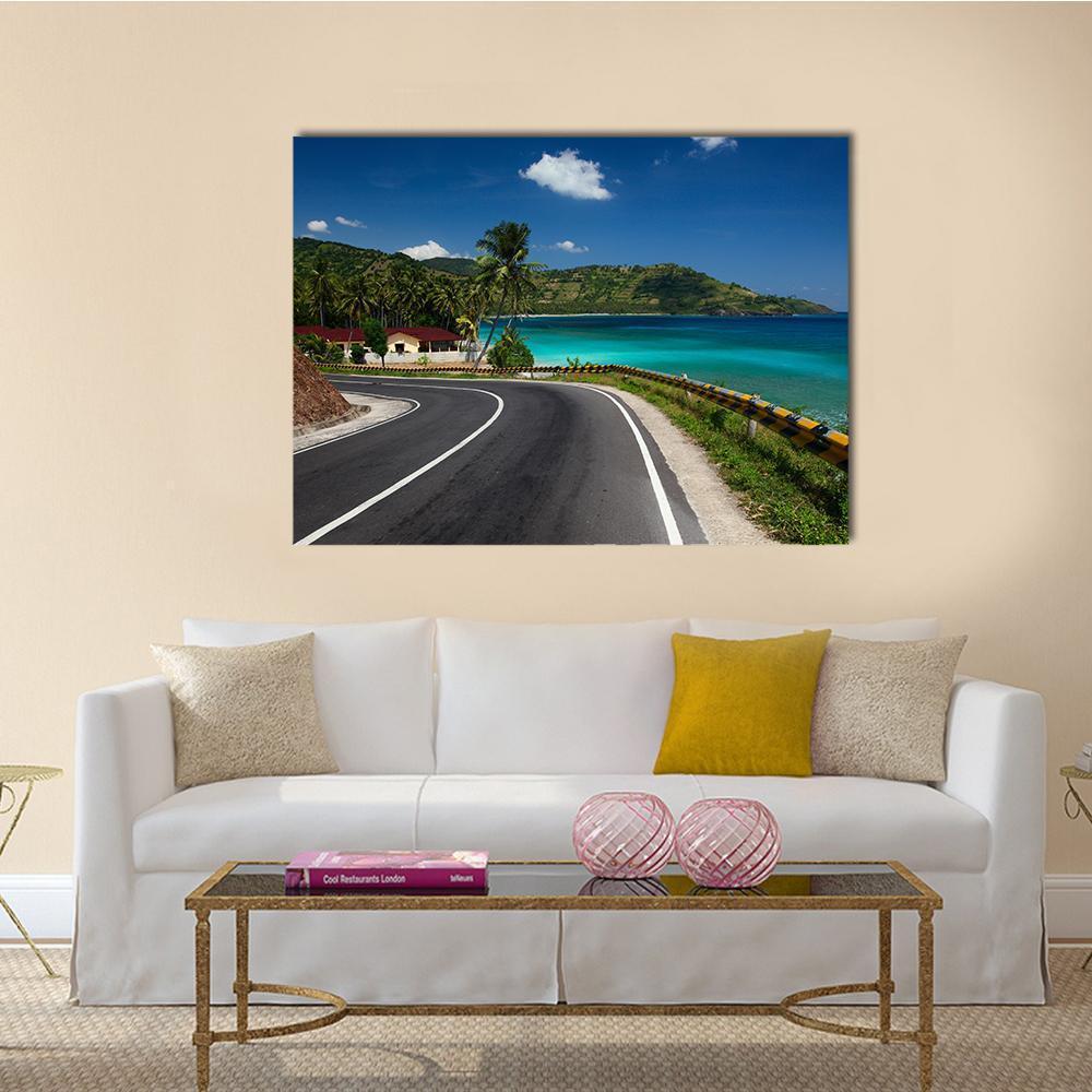 Tropical Coastal Road with Palm Trees Canvas Wall Art in gray, green and blue, single panel hung on a wall