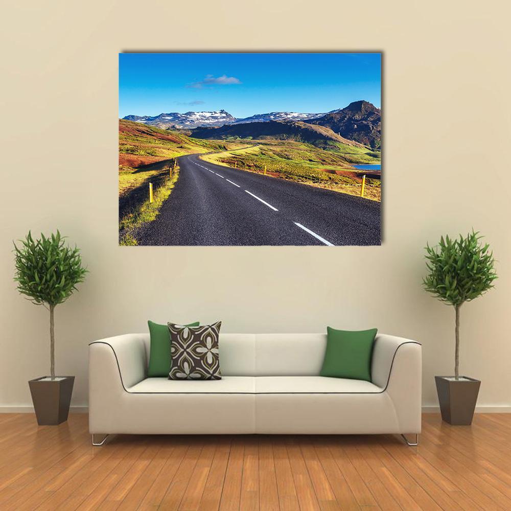 Winding Asphalt Road in Iceland Canvas Wall Art in black, green and blue, single panel hung on a wall