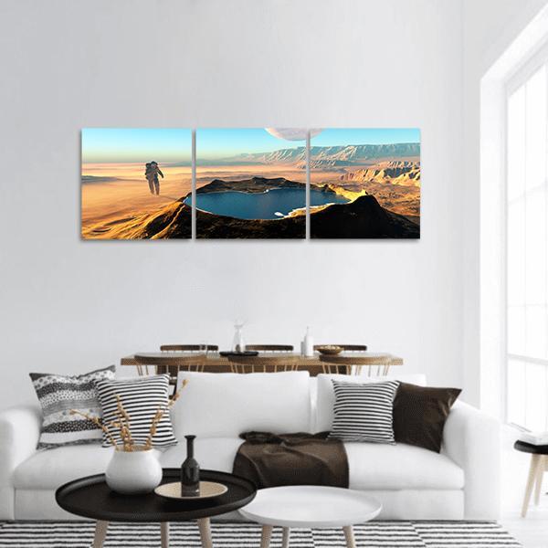 Astronaut at Crater Lake Panoramic Canvas Wall Art in beige, orange and blue, hung on a wall