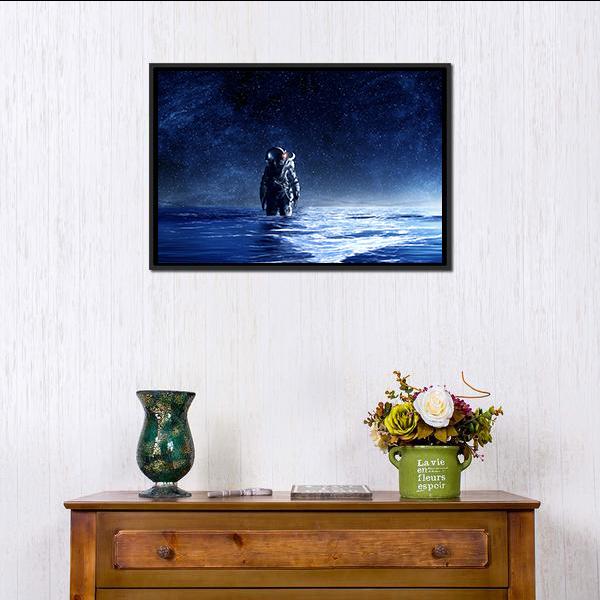 Astronaut Standing in Water Canvas Wall Art in black, blue and navy, framed canvas, product view on a white background