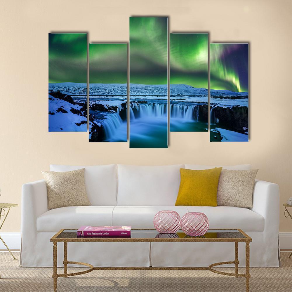 Aurora Over Godafoss Waterfall Canvas Wall Art in green and blue, 3 panel horizontal set hung on a wall