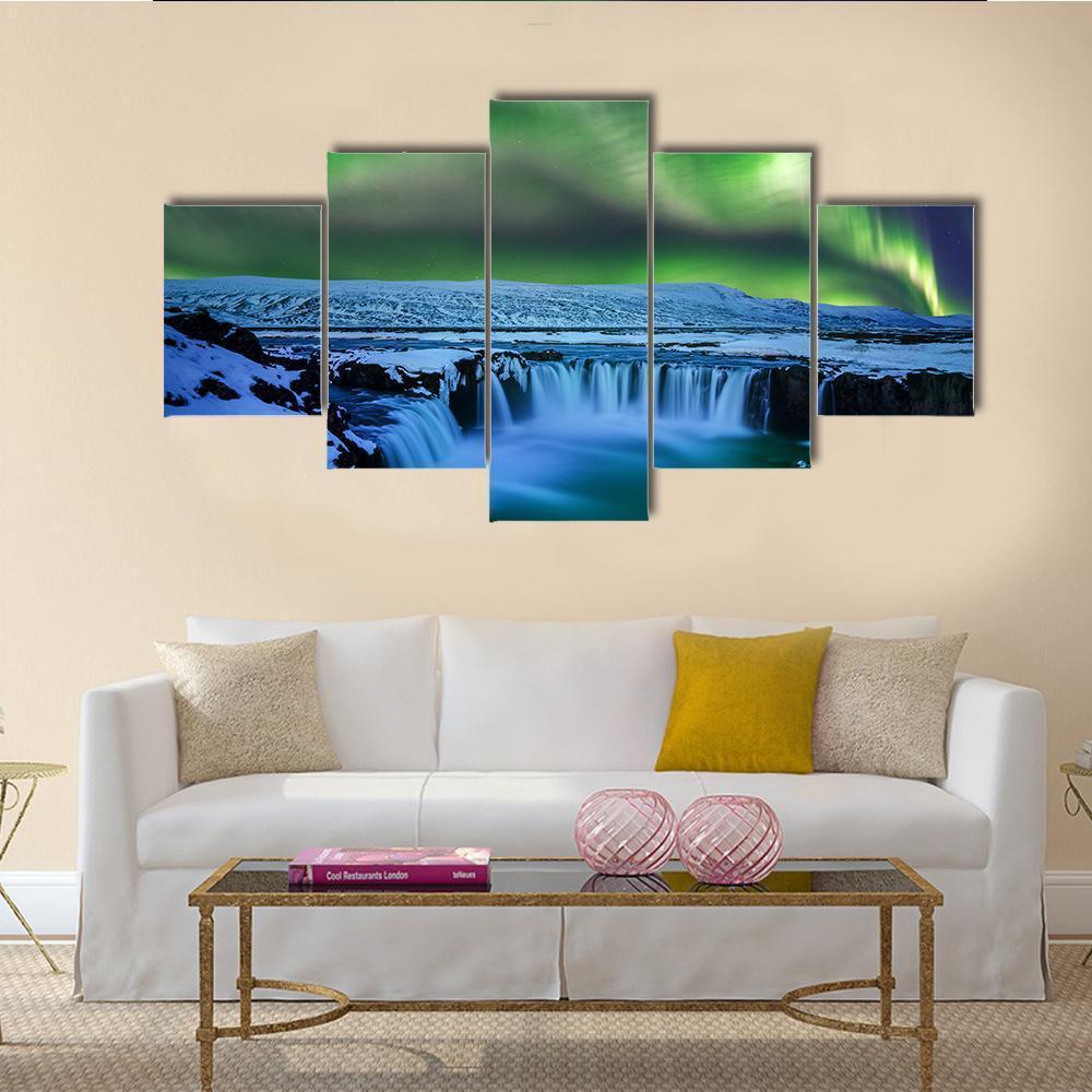 Aurora Over Godafoss Waterfall Canvas Wall Art in green and blue, 3 panel horizontal set hung on a wall
