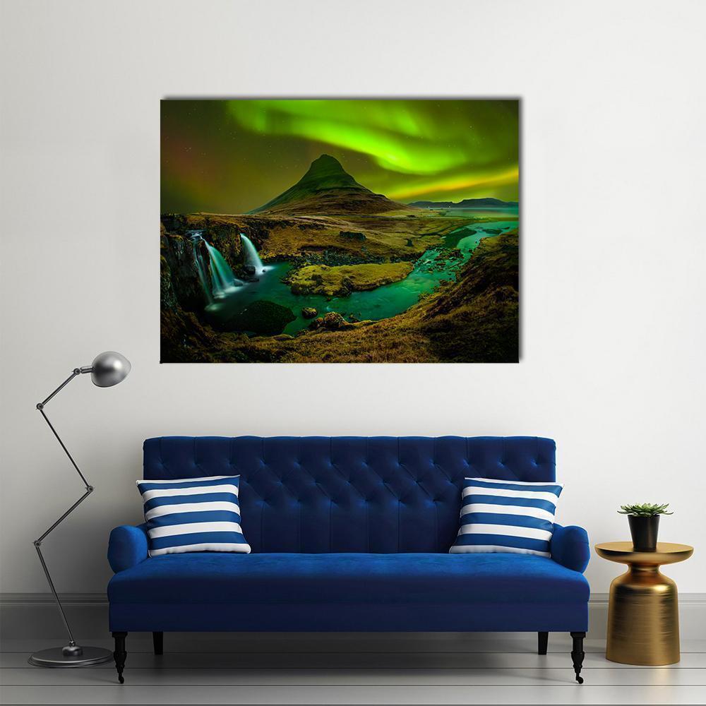 Aurora Over Kirkjufell Waterfall Canvas Wall Art in black, yellow and green, single panel hung on a wall