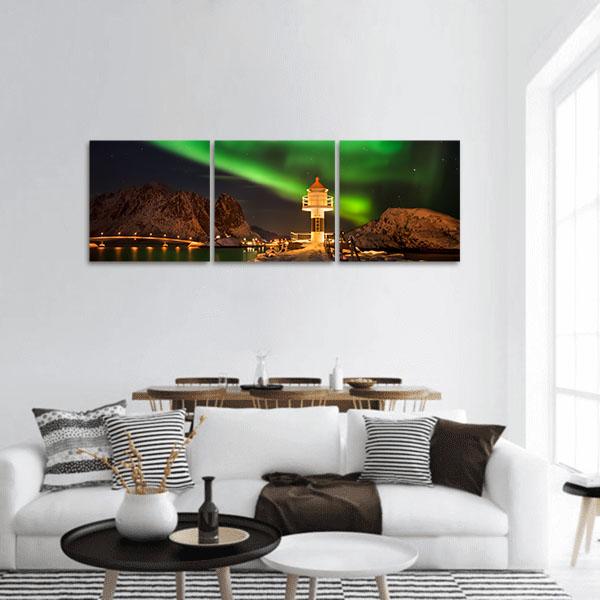 Lofoten Lighthouse Under Northern Lights Panoramic Canvas Wall Art in black, yellow and green, single panel hung on a wall